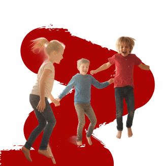 Three children joyfully jump against a bold red and black abstract background. They hold hands, smiling brightly, conveying energy and happiness.