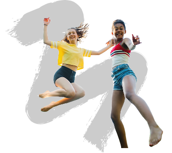 Two people joyfully jump in the air against a black background. They are smiling, wearing casual summer clothes, and appear carefree and spirited.