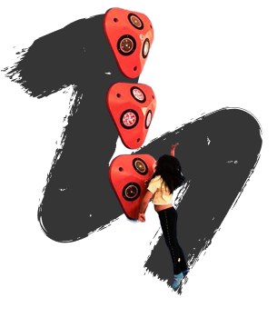 A person boulders dynamically upward against a black background, reaching for the next red climbing hold. The scene conveys a sense of movement and focus.